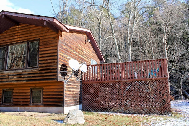 view of property exterior with a deck