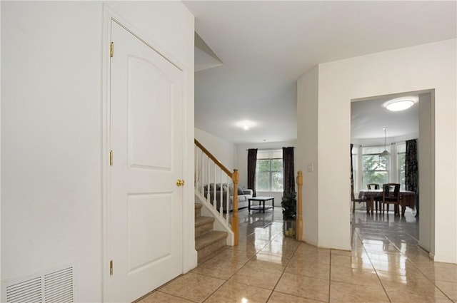 hall featuring light tile patterned floors