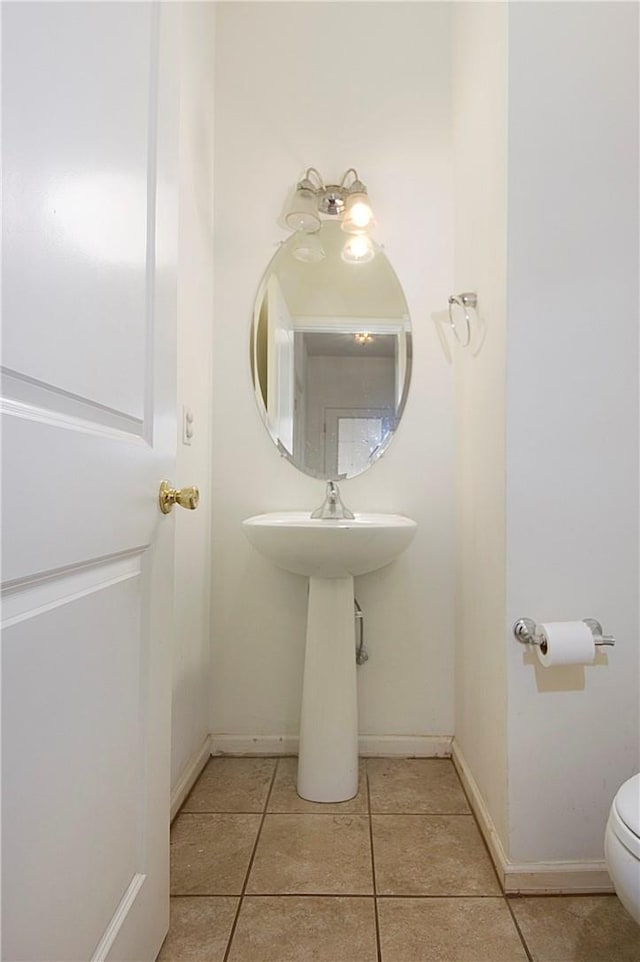 bathroom with tile patterned flooring and toilet