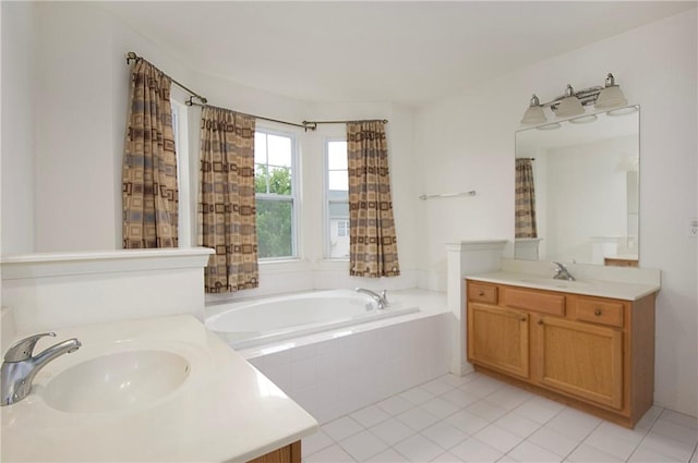 bathroom featuring tile patterned flooring, vanity, and tiled tub