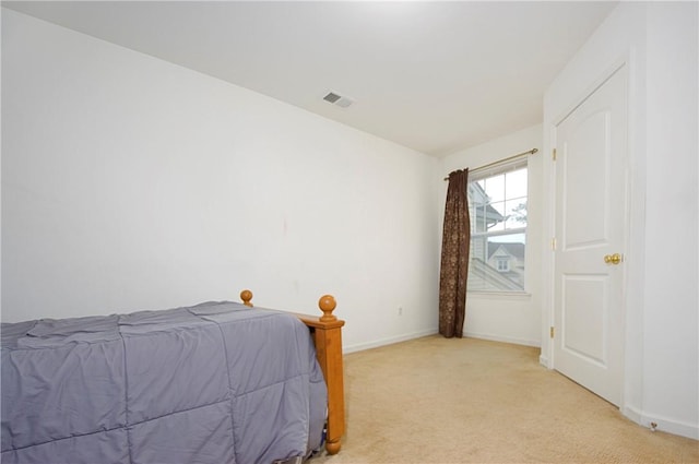 bedroom featuring light colored carpet