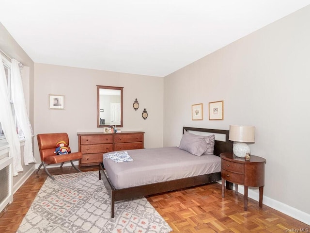 bedroom with light parquet flooring