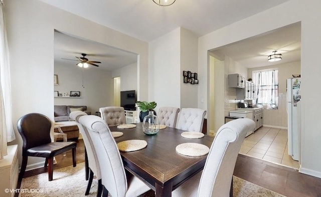 dining space with ceiling fan and light tile patterned flooring