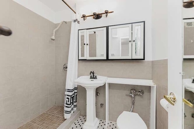 bathroom with curtained shower, tile patterned flooring, and toilet