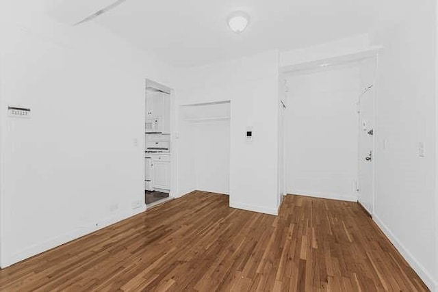 empty room with hardwood / wood-style floors