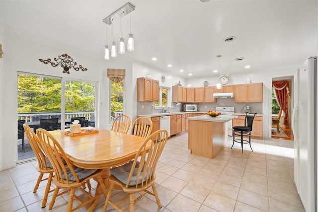 dining space with light tile patterned floors and sink