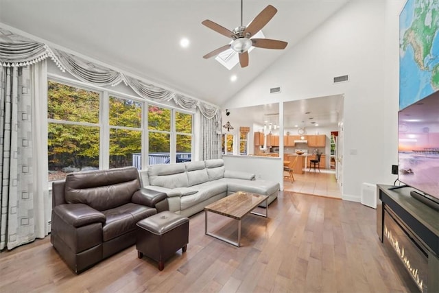 living room featuring ceiling fan, high vaulted ceiling, and wood-type flooring