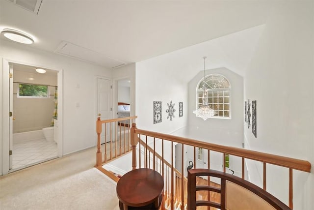 corridor featuring light colored carpet and lofted ceiling