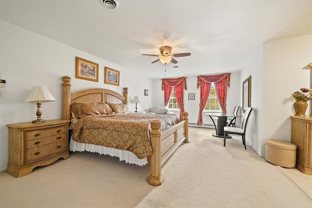 bedroom featuring ceiling fan, baseboard heating, and light carpet