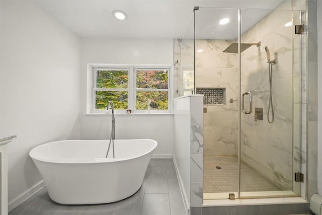 bathroom featuring tile patterned floors and separate shower and tub