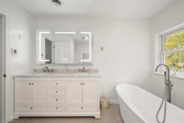 bathroom featuring a tub and vanity