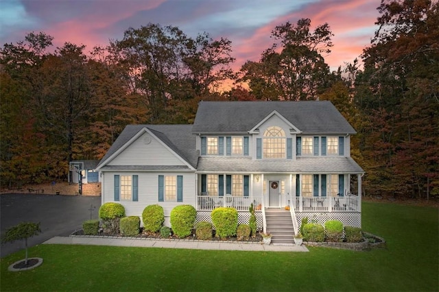 colonial home featuring a yard and a porch