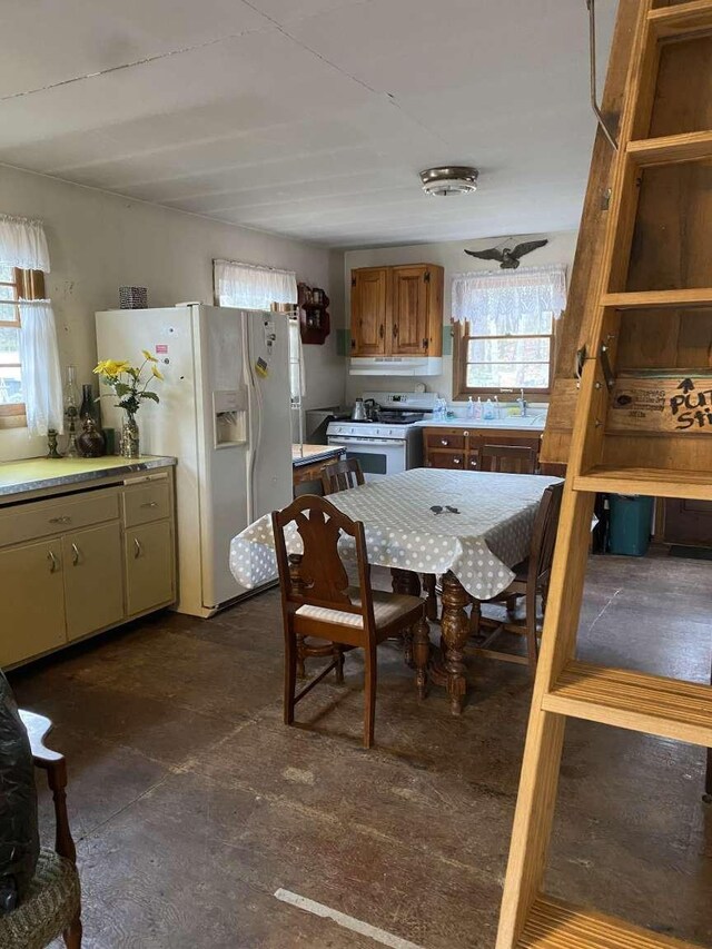 kitchen with white appliances, ceiling fan, and sink