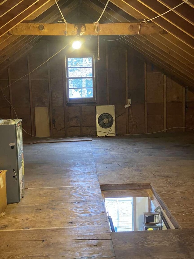 attic with washer / clothes dryer and a wealth of natural light