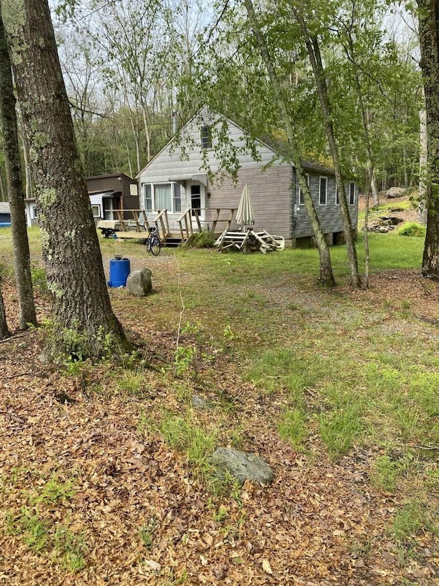 view of yard featuring a wooden deck