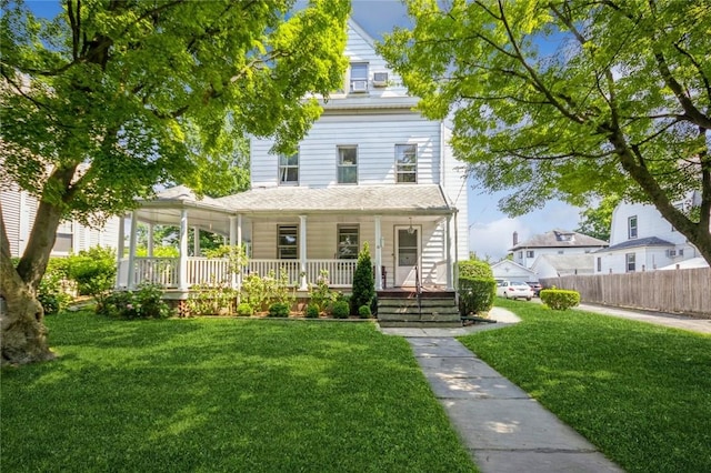 view of front of house with a front yard and a porch