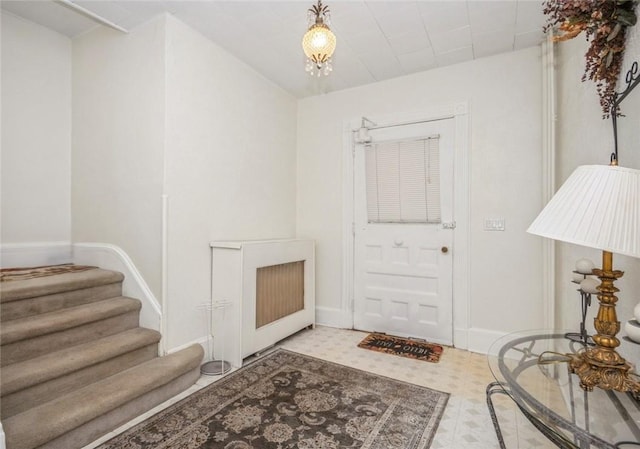 foyer entrance with a notable chandelier