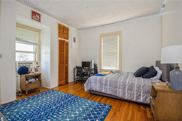 bedroom featuring hardwood / wood-style floors and a textured ceiling