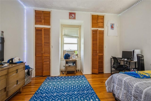 bedroom with hardwood / wood-style flooring and a textured ceiling