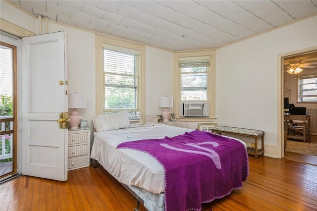 bedroom featuring hardwood / wood-style flooring and cooling unit