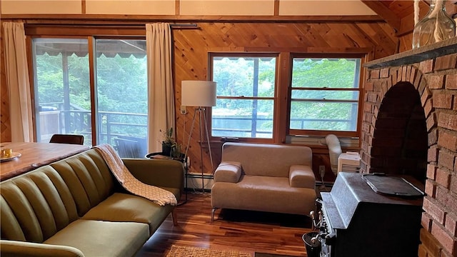 living room with beamed ceiling, wooden walls, a baseboard radiator, and dark wood-type flooring