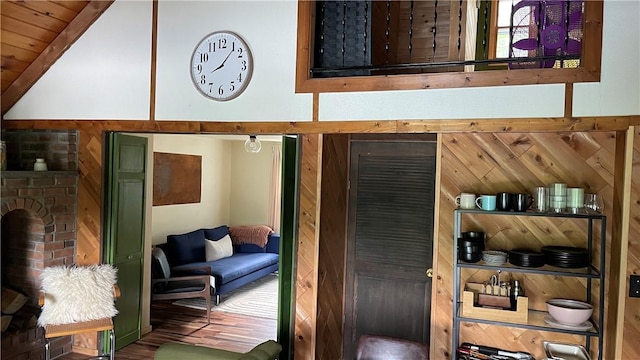 interior space with a fireplace, hardwood / wood-style floors, wooden ceiling, and lofted ceiling