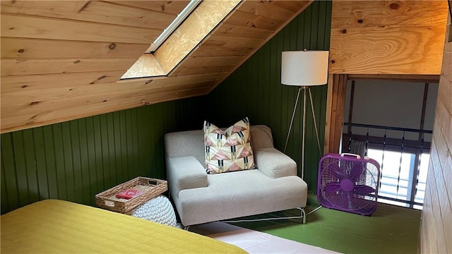 interior space with lofted ceiling with skylight, wooden walls, and wood ceiling