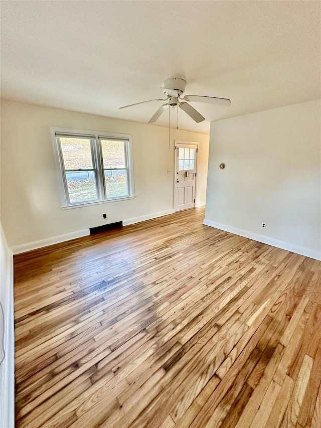 spare room with ceiling fan and light hardwood / wood-style floors