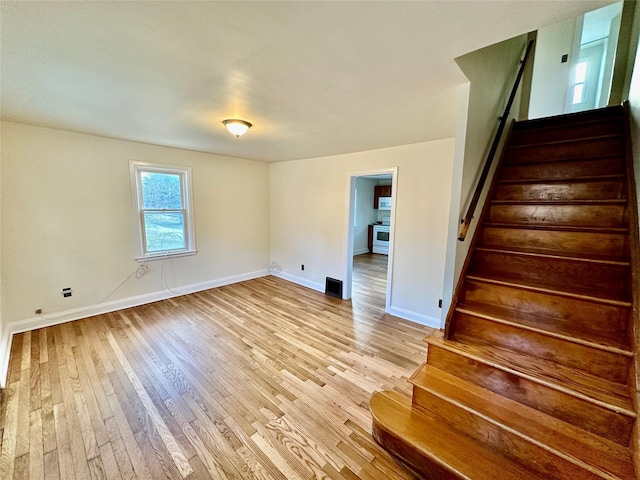 stairs featuring hardwood / wood-style floors