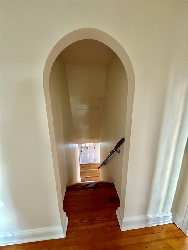 stairway with hardwood / wood-style flooring