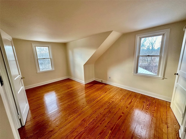 bonus room with hardwood / wood-style flooring and lofted ceiling