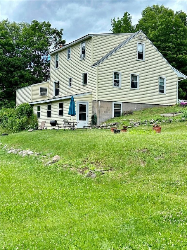 rear view of property featuring a yard