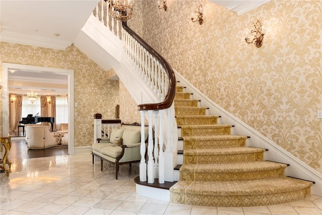stairway with crown molding, baseboards, and wallpapered walls