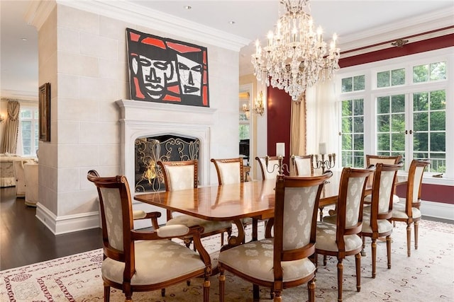 dining space featuring a healthy amount of sunlight, wood finished floors, and a fireplace