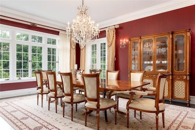 dining space with ornamental molding, baseboards, and a chandelier