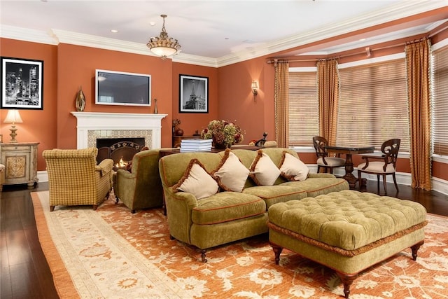 living room with baseboards, a warm lit fireplace, recessed lighting, crown molding, and hardwood / wood-style flooring
