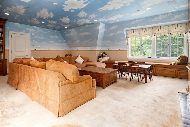 living room with light colored carpet, wainscoting, and wallpapered walls