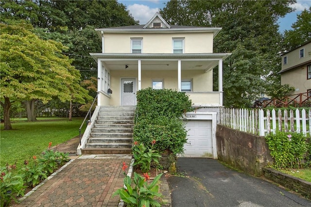 view of front facade featuring a front yard and a garage