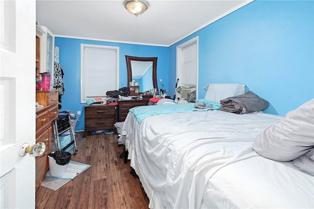 bedroom featuring dark hardwood / wood-style floors and crown molding