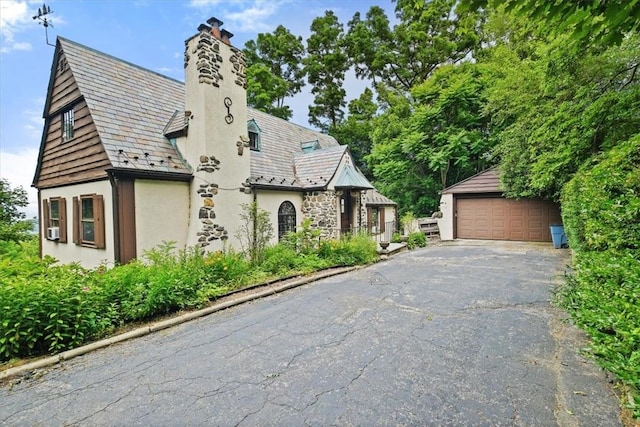 view of front of property with a garage and an outdoor structure