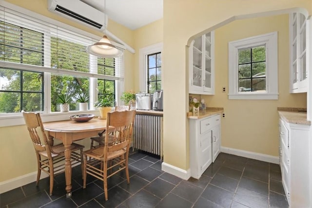 dining room with radiator and a wall mounted AC