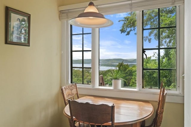 dining area with a water and mountain view