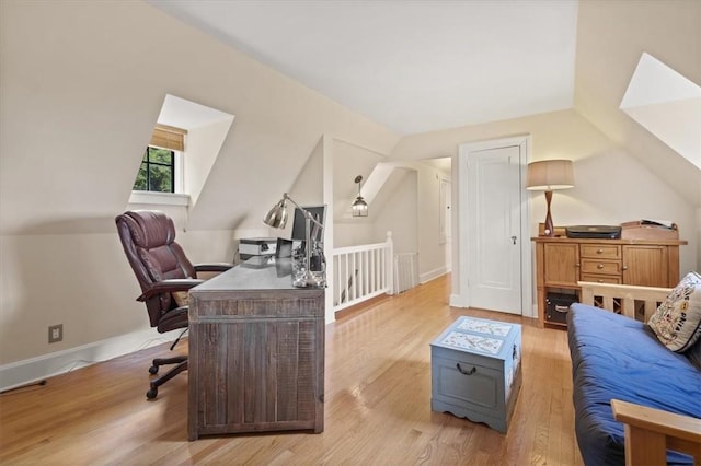 office space with lofted ceiling and light hardwood / wood-style flooring