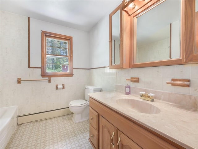 bathroom with a washtub, a baseboard radiator, toilet, vanity, and tile walls