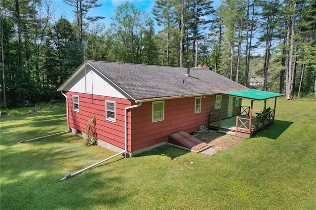 rear view of house featuring a lawn