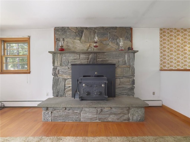 1124 State Route 42, Sparrowbush, NY 12780 - detailed view of a baseboard heating unit, wood finished floors, baseboard heating, and a wood stove