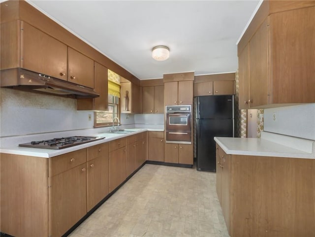 1124 State Route 42, Sparrowbush, NY 12780 - kitchen with freestanding refrigerator, wall oven, stainless steel gas stovetop, a warming drawer, and under cabinet range hood