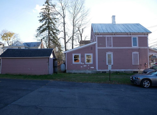 view of home's exterior with a storage unit