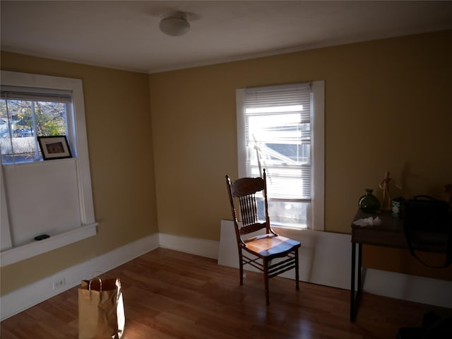 living area with hardwood / wood-style flooring