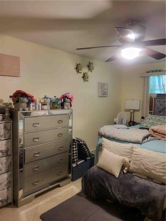 bedroom with ceiling fan and light tile patterned floors